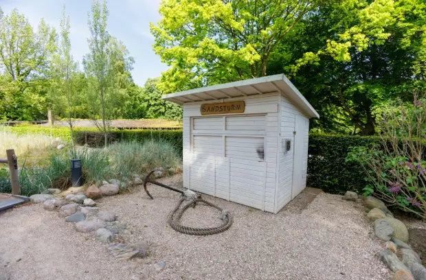 Compact wooden garden shed ideal for lawn mower and garden tool storage.